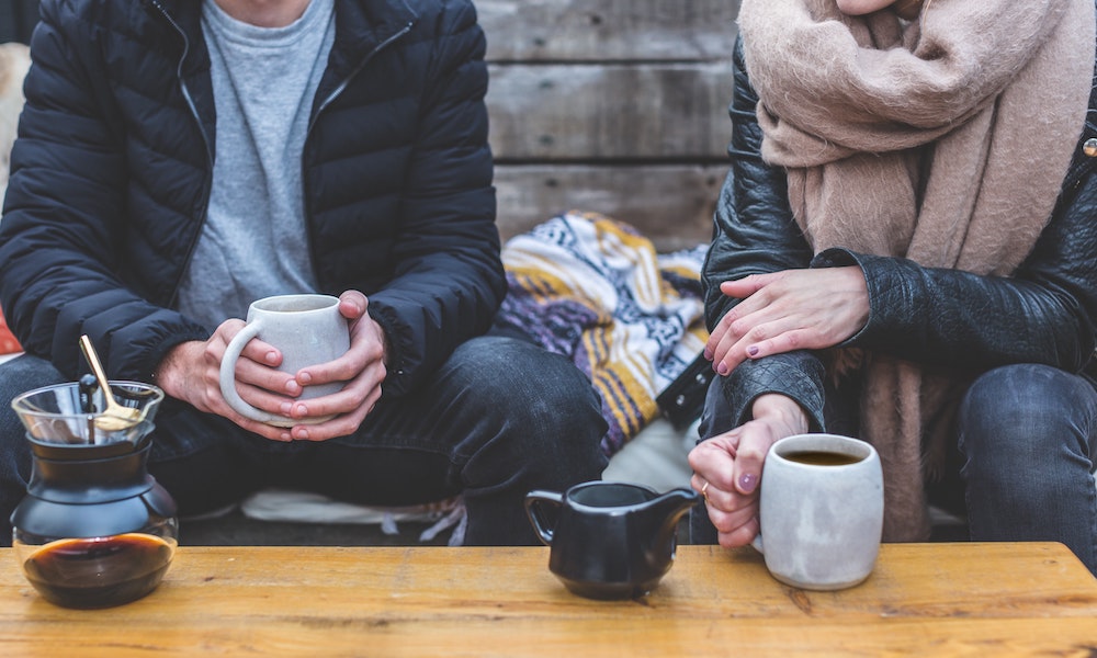 Two teenagers drinking coffee